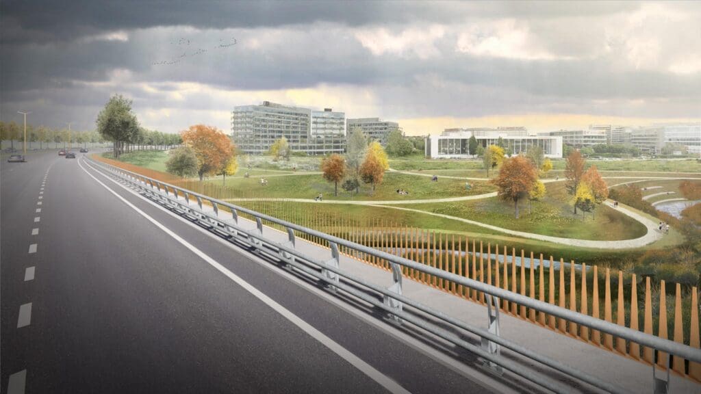 A road with a green park and urban landscape in the background.