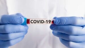 COVID-19 test tube being held by scientist