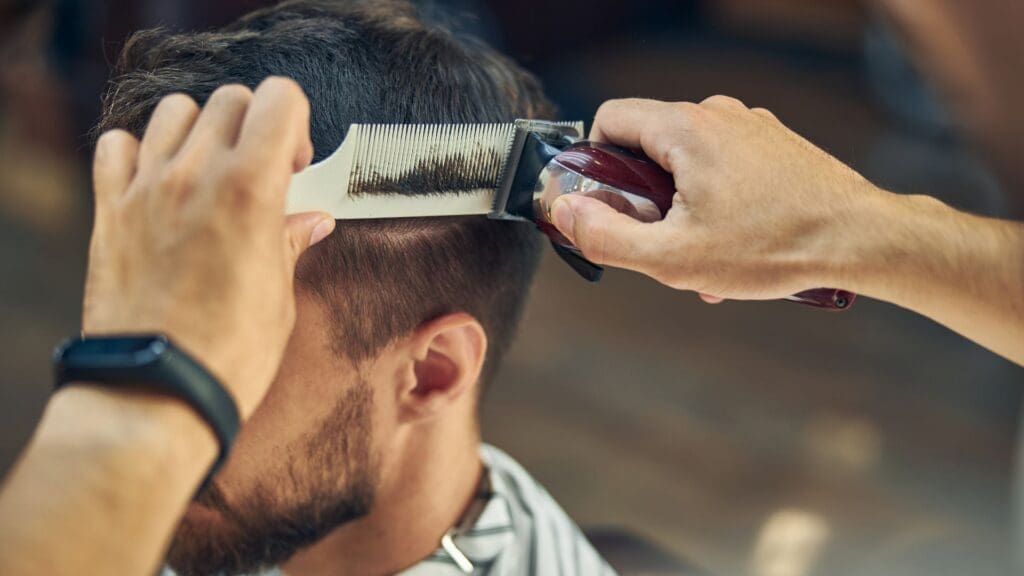 Barber cutting a mans hair